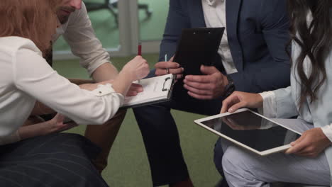 a working group of two businesswomen and two businessmen in the middle of a brainstorming session 7