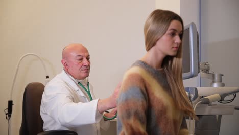 doctor examining a patient with a stethoscope and ultrasound machine