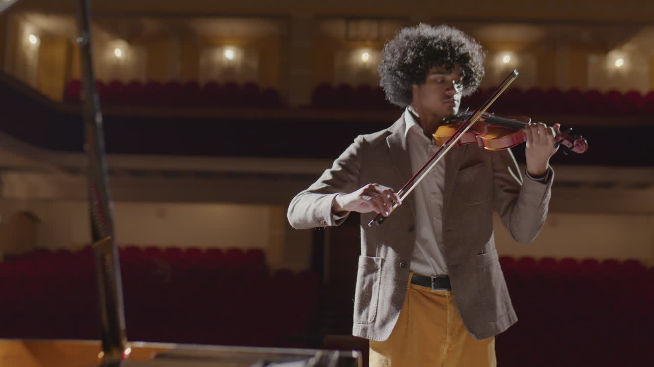 African American Violin Player Practicing in Music Hall