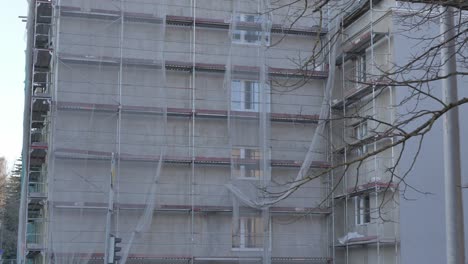 House-is-being-renovated-on-Riia-street-in-Tartu,-house-is-surrounded-by-scaffolding