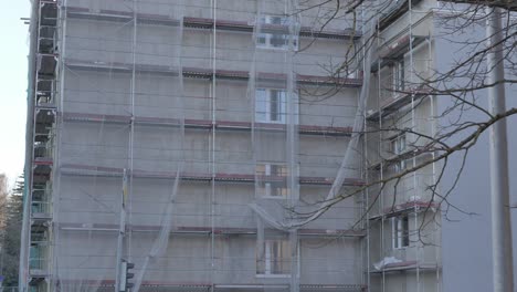 house is being renovated on riia street in tartu, house is surrounded by scaffolding