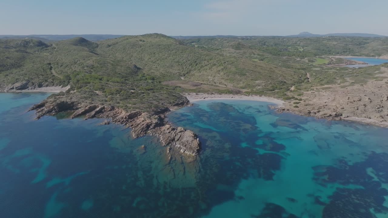 Panoramic Drone Zooms out Mediterranean Coastline beach secluded Menorca island Spain, Cala Sa Torreta