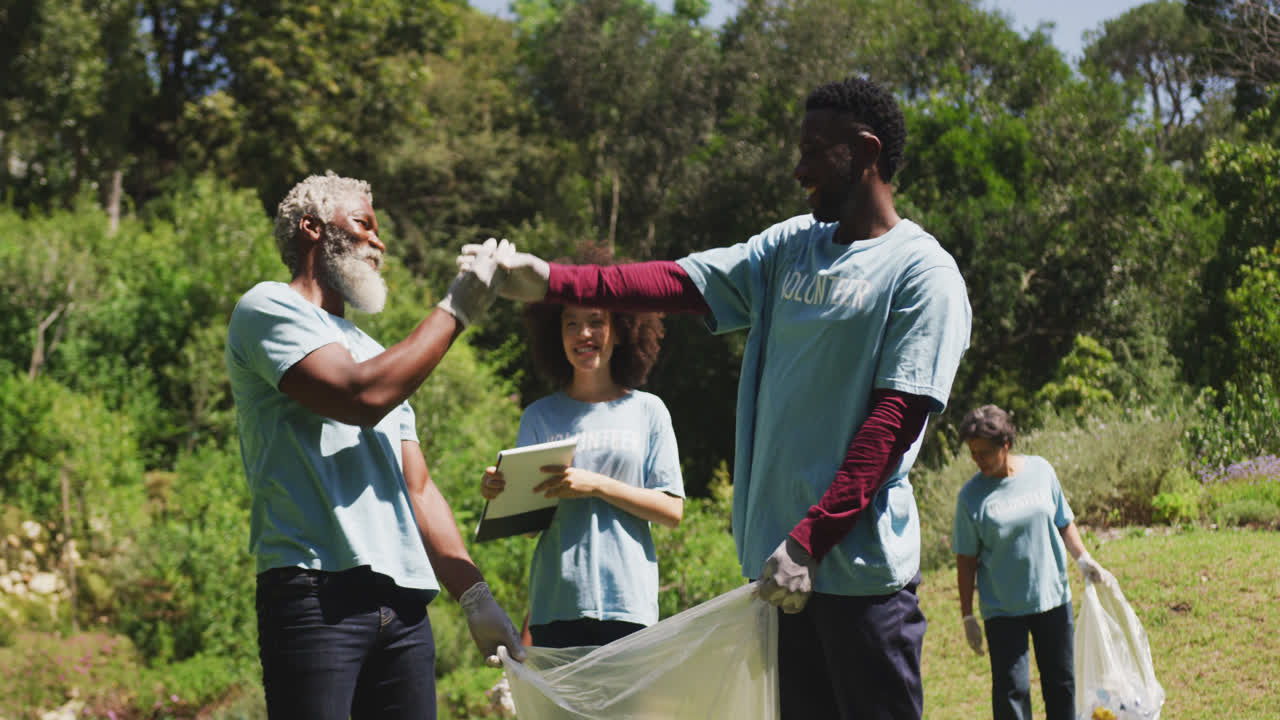 Happy family cleaning a garden together