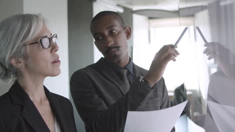 male consultant explaining financial diagrams to female client