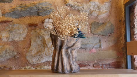 dried flowers arrangement in a rustic vase