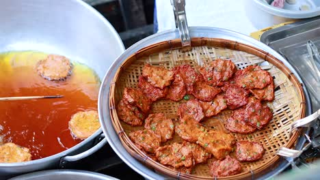 fish cakes frying at bangkok floating market