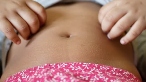 child's stomach being touched