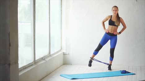 woman doing leg exercise with resistance band