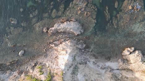 Bird's-Eye-View-Flying-from-Beach-Cliff-to-Ocean