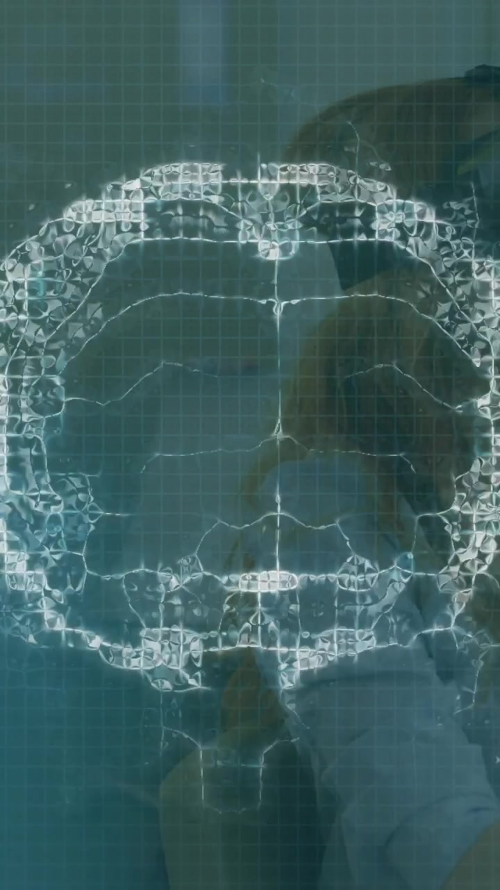 Animation of brain scan and medical data processing on interface, over woman using vr headset