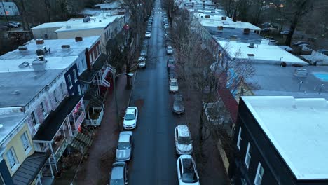 parking cars in straight narrow road in dense american population at dusk