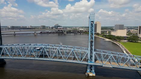 main street, john t alsop, bridge in jacksonville florida viewed from sliding backing drone with train and boat in background