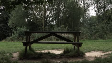 picnic bench in countryside park wide panning shot