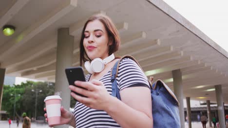 young caucasian woman drinking coffee while chating on phone