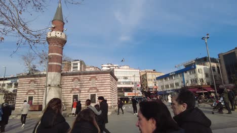 turkish city square with mosque and people
