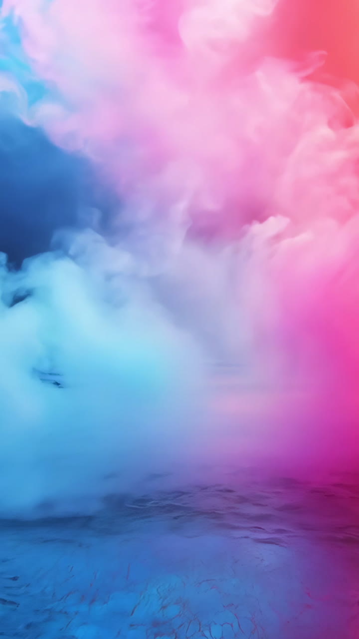 A large, empty stage with a colorful light show featuring red, blue, and purple lights. The stage is empty and the lights are on, creating a vibrant and dynamic atmosphere