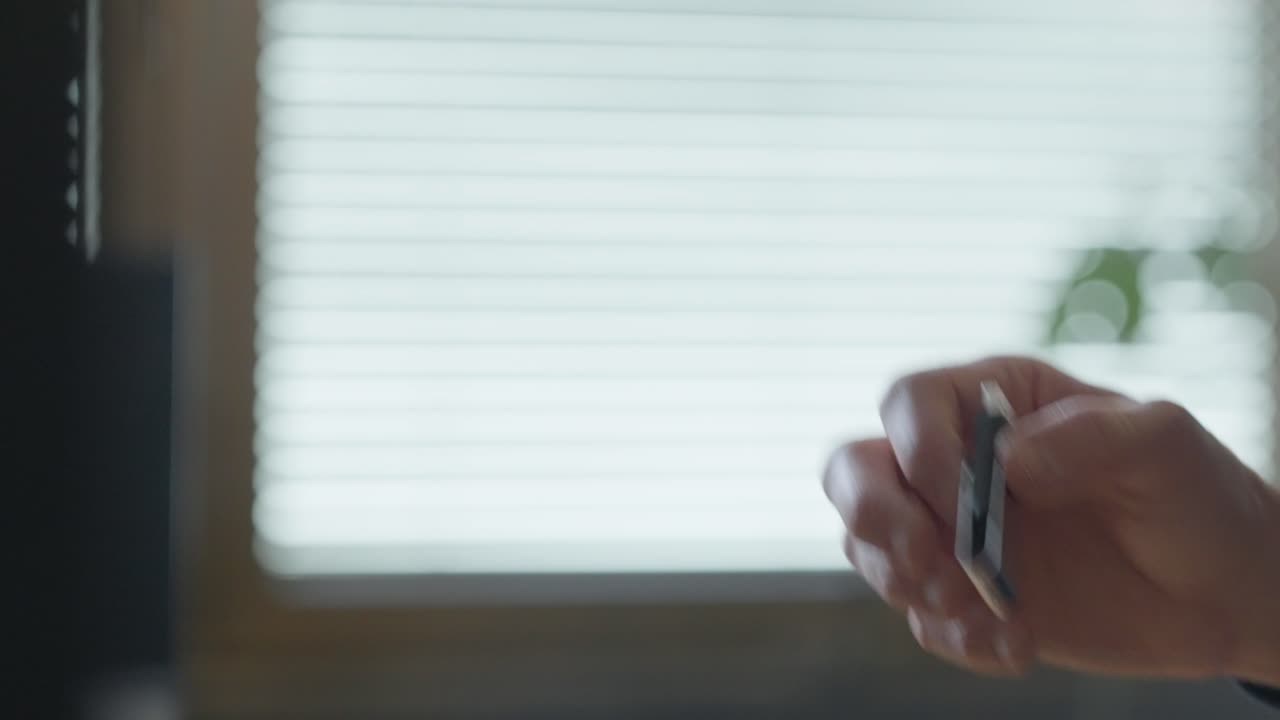 USB flash drive being handed from one person to another in a secret exchange. Close-up. Digital data transfer, confidential information, espionage, hacking, cybersecurity, intelligence, or spy word