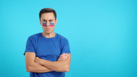 Dignified and serious man with haitian flag painted on face