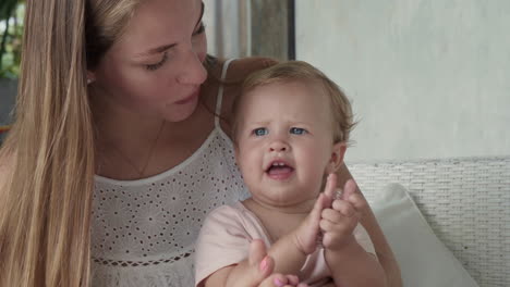 mom and baby girl clapping hands