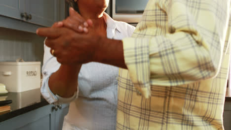 Senior-couple-dancing-in-kitchen