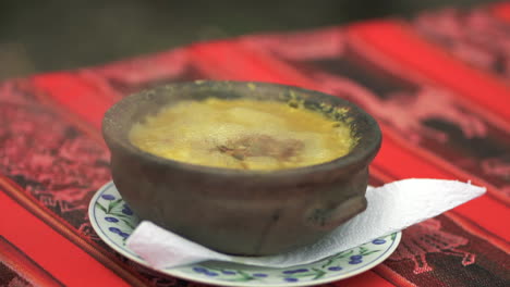 Close-up-orbit-View-of-Typical-Locro-Argentine-Stew-Served-in-a-Casserole,-Slow-Motion