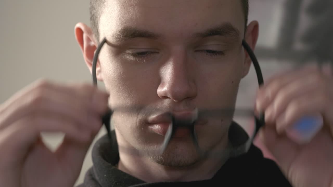 Man Wearing Eye Glasses While Looking Straight To The Camera - Close Up Shot