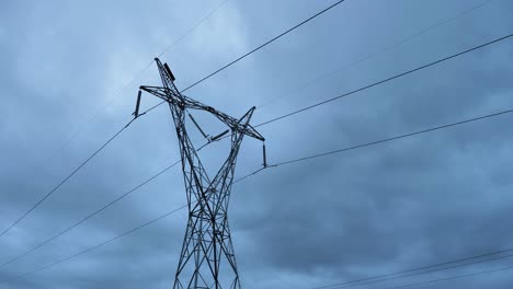 Low-wide-view-of-high-voltage-power-lines-on-a-cloudy-overcast-day