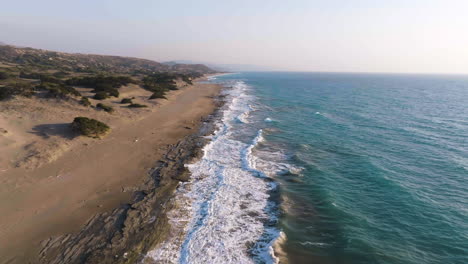 aerial view flying along the limni beach, sunny evening in rhodes, greece