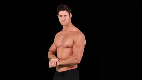 Muscular-man-flexing-muscles-in-front-of-camera