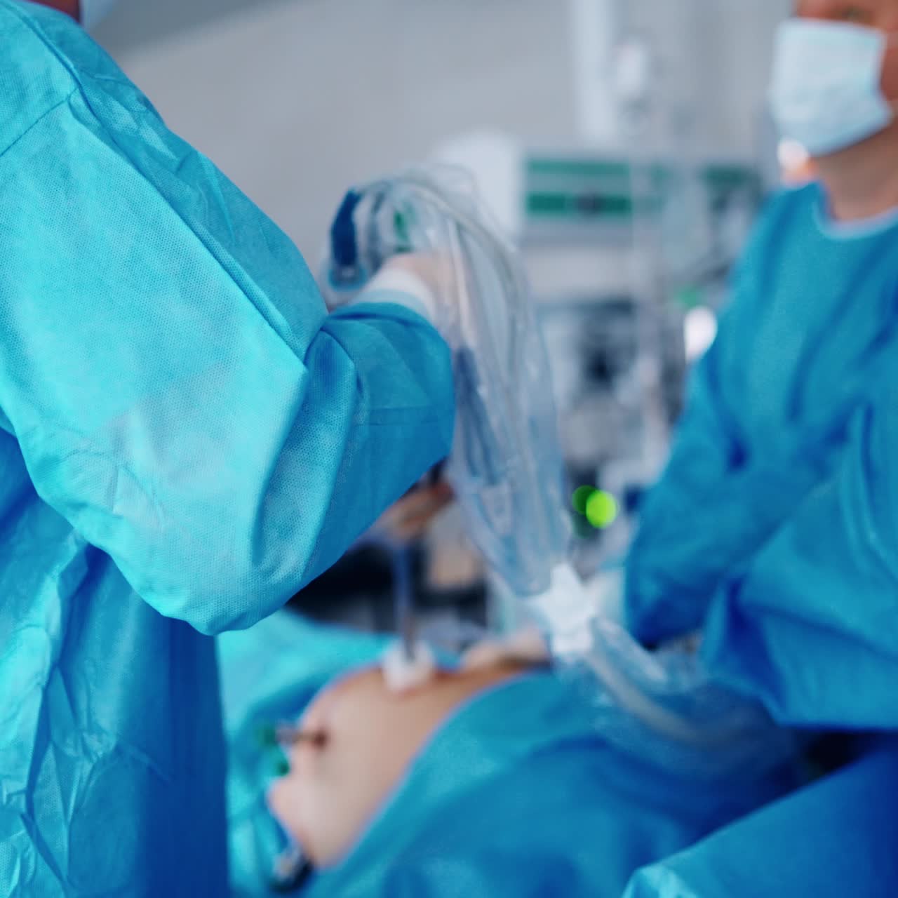 Surgical process with robotic device. Team of surgeons in protective uniform perform an operation in the hospital. Doctors use hi-tech equipment. Close-up.