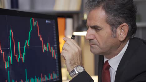 stock trader mature man following the stock market thoughtfully.