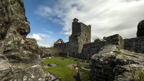 Motion-time-lapse-of-Creevelea-Abbey-medieval-ruin-in-county-Leitrim-in-Ireland-as-a-historical-sightseeing-landmark-and-graveyard-with-dramatic-clouds-in-the-sky-on-a-summer-day