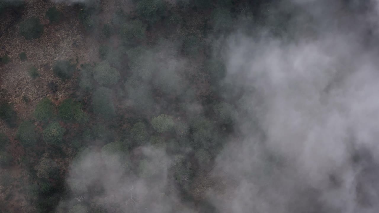 Aerial drone shot of the Paso de Cortés through a cloud bank in Mexico
