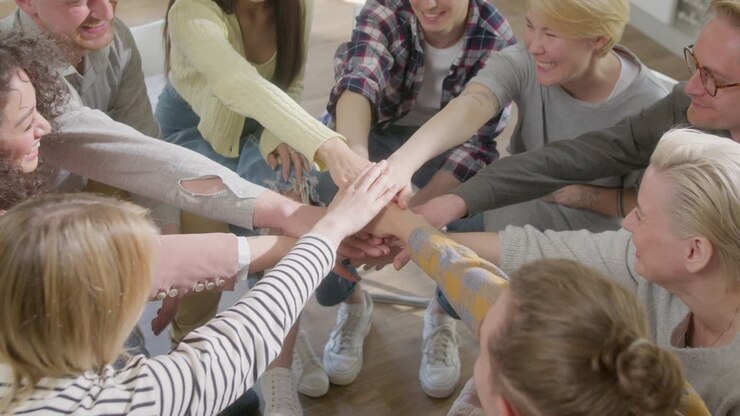 College Students Teamwork Join Hands Partnership Concept. Group of Young People Employee joining stack hands together