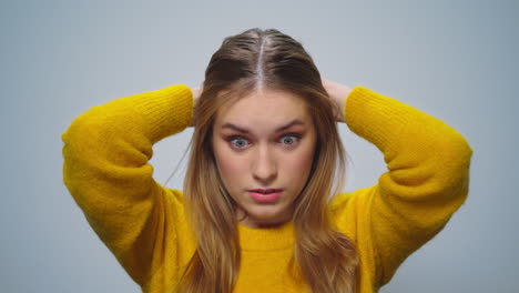 Portrait-of-disappointed-woman-feeling-doubtful-on-grey-background.-Upset-girl