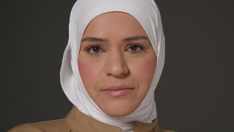 close up studio head and shoulders portrait of muslim woman wearing hijab 1