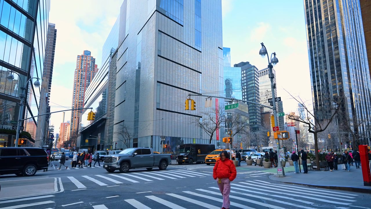 New York, USA, 15 April 2026: Cyclists and pedestrians at Columbus Circle intersection New York. Urban activity at West 58th Street intersection with cyclists and modern glass buildings