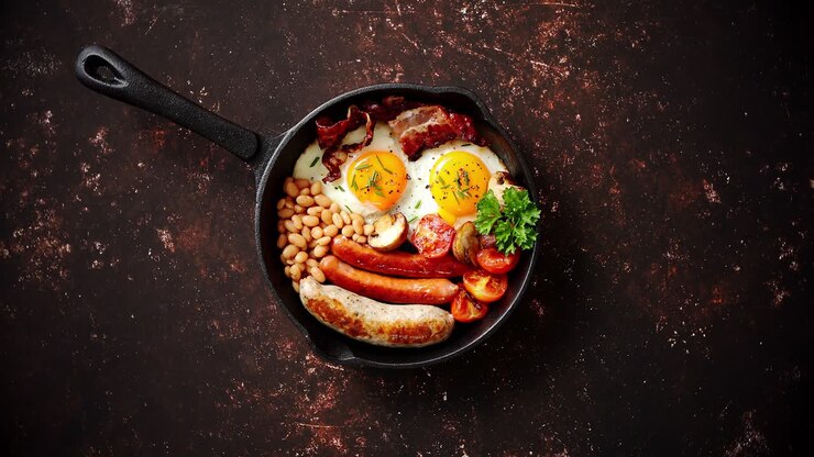 Delicious english breakfast in iron cooking pan
