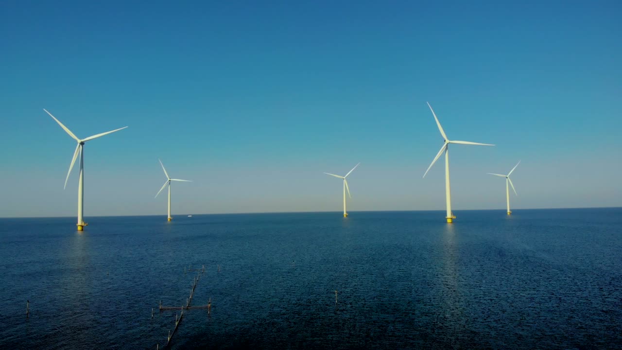 Windmill turbines, Offshore Windmill farm in the ocean Westermeerwind park , windmills isolated at sea on a beautiful bright day Netherlands Flevoland Noordoostpolder
