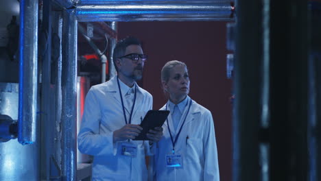 scientists inspecting industrial equipment