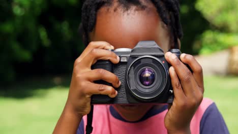 Portrait-of-little-boy-taking-picture-