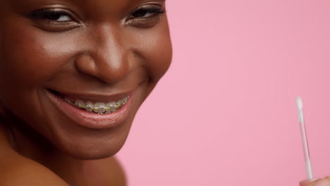 woman with braces and cotton swab
