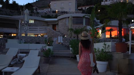 beautiful girl walking towards the city of dubrovnik and looking back to the camera and smile