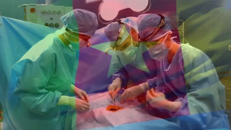 animation of flag of cameroon waving over surgeons in operating theatre