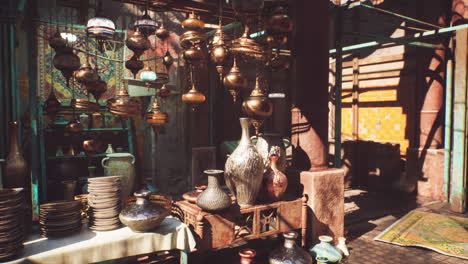 traditional moroccan market stall with lamps, vases and pottery