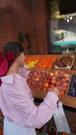 woman shopping at a fruit stand