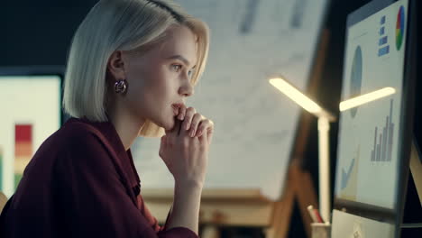 thinking business woman working in night office. tired woman in dark office