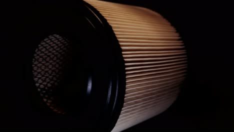 car air filter rotating on a turntable in the dark