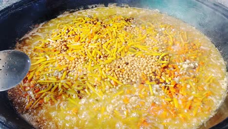 a man prepares plov or osh at the central asian plov centre in tashkent, uzbekistan