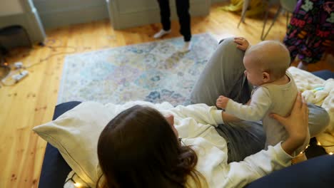 mother and baby playing on sofa